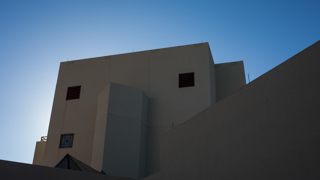 Image of building on campus with the sun behind it