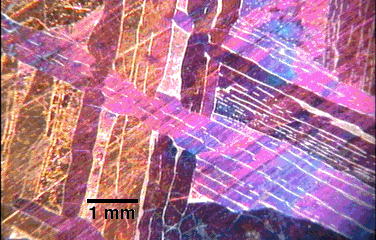 Image of a red, pink and blue crystalline pattern.